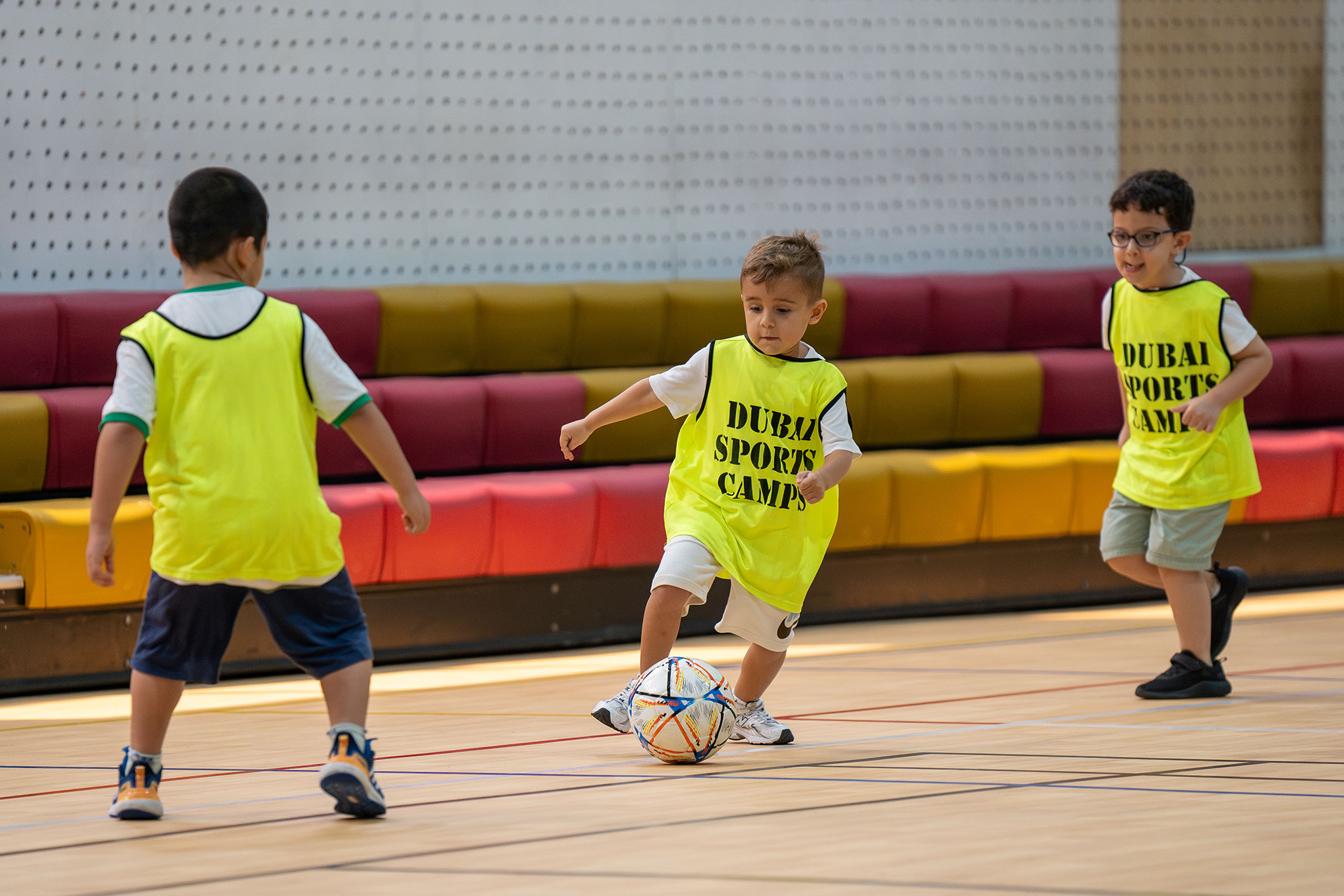 Children learning football techniques and teamwork during camp sessions